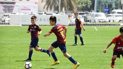 Etihad Sports Academy (plain red) go up against Luceafarul from Romania (red/blue strips) in the under 12 age group.
