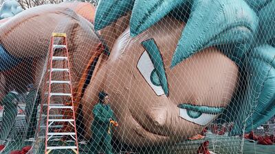 Workers inflate a balloon of the Dragonball character Goku as the balloon is readied for the Macy's Thanksgiving Day Parade. AP