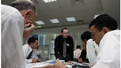 Alan Lanes, of Sharjah Women's College, leads an English writing workshop for public school teachers at the Sharjah Men's College.