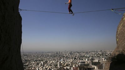 Iranian Hamed Heidari walks across a slackline anchored between two rocks during practice in the mountains overlooking Tehran, Iran. He is one of a growing number of Iranians embracing the extreme sport. Vahid Salemi/AP Photo