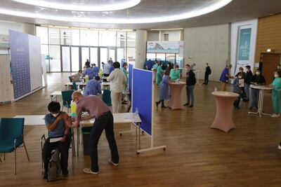 People receive coronavirus vaccines in Cologne, Germany, on Sunday. Getty Images