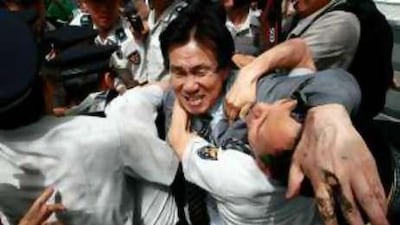 Police try to break up protesters trying to burn a North Korean flag during an anti-North Korea rally yesterday in Seoul.