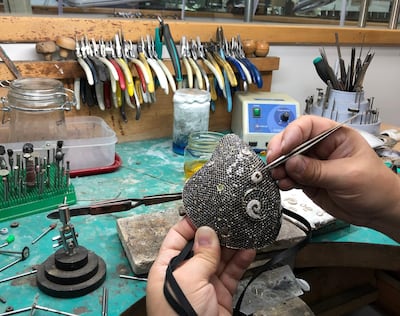 The diamond-encrusted face mask being assembled at the Yvel atelier in Israel. Courtesy Yvel
