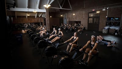 The Radcliffe Women's Heavyweight Crew team warms up on rowing machines before the 55th Head of the Charles Regatta on Sunday, October 20, in Boston, Massachusetts. AFP