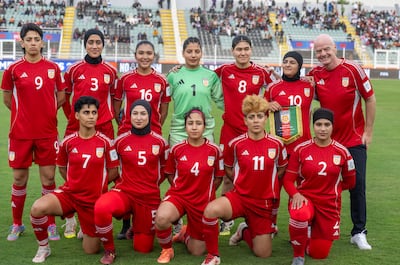 Fifa President Gianni Infantino joins the team picture of Afghan Women United. EPA