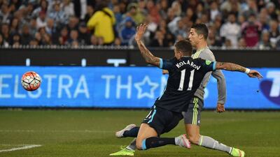 Real Madrid midfielder Cristiano Ronaldo shoots to score his side's second goal against Manchester City on Friday in a pre-season friendly. Paul Crock / AFP