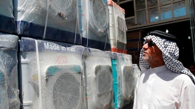 A customer looks at Iranian-made washing machines at a shop in Baghdad. AFP