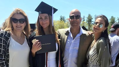 In this May 2019 file photo provided by Guila Fakhoury, her father Amer Fakhoury, second right, gathers with family members at the University of New Hampshire in Durham, New Hampshire. AP
