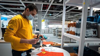 A member of staff tags items ahead of opening. Victor Besa / The National