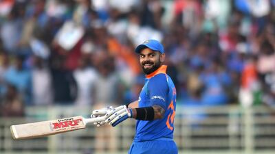 Indian cricket captain Virat Kohli smiles after completing to score 10,000 runs, surpassing the Indian cricket legend Sachin Tendulkar in the ODI format, during the second one day international (ODI) cricket match between India and West Indies. AFP