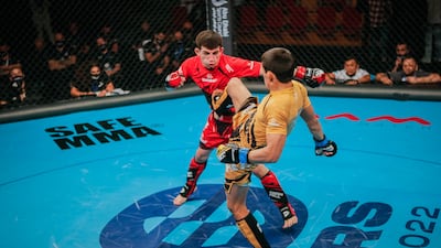 Bagdat Zhubanysh (in yellow) kicks Farkhod Rakhmonaliev during their 2021 IMMAF World Championships bout in Abu Dhabi. All photos: IMMAF
