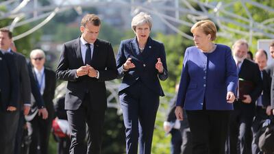 French President Emmanuel Macron, British Prime Minister Theresa May and German Chancellor Angela Merkel walk during the EU-Western Balkans Summit in Sofia, Bulgaria on 17 May 17. All three leaders will send representatives to the closed-door meetings in Tehran. Stoyan Nenov / Reuters