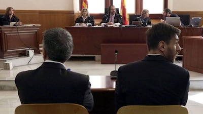 Barcelona's football star Lionel Messi (R) and his father Jorge Horacio Messi listen as they face judges in a tax fraud case at the courthouse of Barcelona on June 2, 2016. Alberto Estevez / AFP