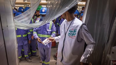Refrigerated trucks deliver cold drinks to outdoor work sites and fridges are installed in workers' accommodation to maximise access to refreshments in the harsh summer heat. Antonie Robertson/The National