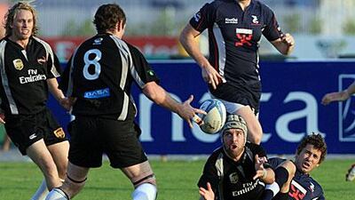 Dubai Hurricanes, pictured in black playing Dubai Dragons, are fighting to keep the Gulf Top Six trophy.