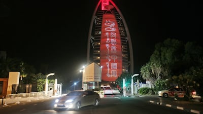 A sign reading "UAE Chinese Week" in Chinese and Arabic is projected on to the Burj Al Arab hotel to mark Chinese President Xi Jinping's trip to the UAE. AP