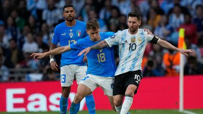 Italy's Nicolo Barella and Lionel Messi battle for the ball. AP