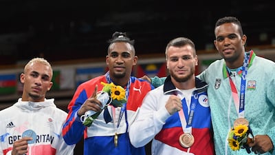 Silver medallist Benjamin Whittaker of Britain, gold medallist Arlen Lopez of Cuba, bronze medallists Russia's Imam Khataev and Azerbaijan's Loren Berto Alfonso Dominguez.