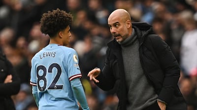 Manchester City manager Pep Guardiola speaks to Rico Lewis. AFP