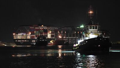 Tugboats by the Panama-flagged MV Ever Given. AFP