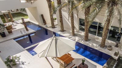The villa's wings have large glass windows looking onto the central space, which features a 25-metre infinity pool. Courtesy Luxhabitat