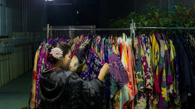 A woman browses through kimonos for sale at the Boroichi flea market in Tokyo. Vintage kimonos in vermillion red and prints of cranes go for as little as ¥1,000. Thomas Peter / Reuters