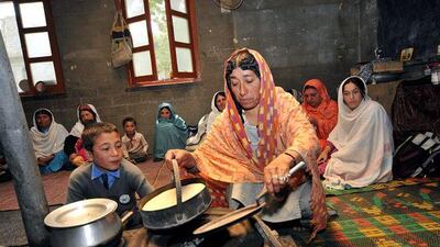 A displaced woman prepares food at the Aga Khan Diamond Jubilee School at Altit in the Hunza Valley.