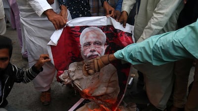 People burn picture of Indian Prime Minister Narendra Modi after reports of Pakistani Air Forces shooting down India fighter jets, in Karachi, Pakistan, 27 February 2019. EPA
