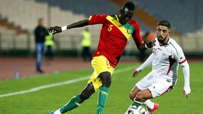 Guinea's Issiaga Sylla, left, dribbles around Iran's Ashkan Dejagah, right, during their international friendly on Wednesday March 5, 2014 in Tehran. Abedin Taherkenareh / EPA