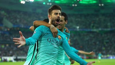 Gerard Pique of Barcelona celebrates with teammates Luis Suarez and Sergio Busquets after scoring his team’s second goal. Alex Grimm / Getty Images