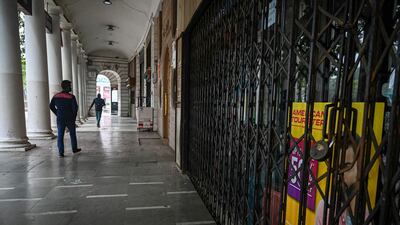 A man walks past closed shops during a state-wide weekend curfew to curb the spread of Covid-19 in New Delhi, India, on January 15. All photos: Prakash Singh / AFP