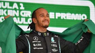 Mercedes' British driver Lewis Hamilton celebrates on the podium after winning Brazil's Formula One Sao Paulo Grand Prix. AFP