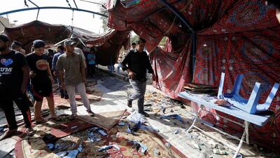 People gather at the site of a suicide bomb attack in the Baghdad’s northern Shaab district on October 15, 2016. Ahmed Saad / Reuters