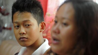 Reynaldo Nilo has been cared for by his sister Sarah Joy ever since he dropped out of high school because of illness. Jay Directo / AFP