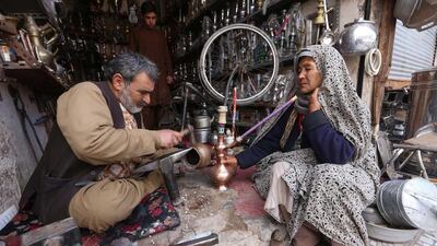 An Afghan black smith works on water pipes in Herat, Afghanistan. Jalil Rezayee / EPA