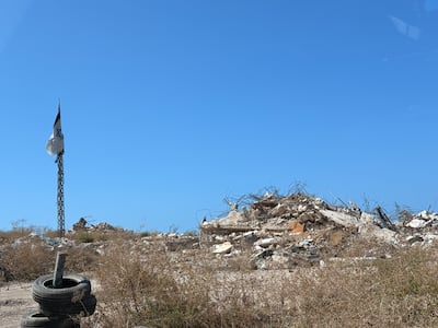 An Israeli flag flies over the ruins of destroyed buildings in southern Lebanon. Nada Homsi / The National
