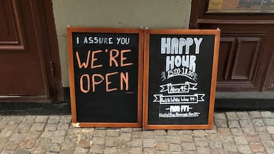 A sign assures people that the bar is open during the coronavirus outbreak, outside a pub in Stockholm, Sweden March 26, 2020. Reuters