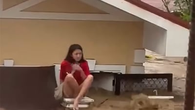 A video of Oshea Aguirre, a Philippine teenager has gone viral that shows her trapped in swirling flood water crouched on a gate near her submerged home in Cebu, Philippines that was hit by Typhoon Fung-wong. Photo: Aezel Aguirre / Facebook