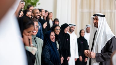 President Sheikh Mohamed with members of the Eid Al Etihad organising team. Photo: Abdulla Al Bedwawi / UAE Presidential Court