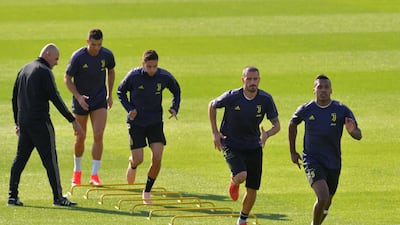 Cristiano Ronaldo, Alex Sandro and Leonardo Bonucci (2ndR) run during a training session. AFP