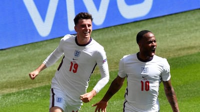 England's Raheem Sterling, right, reacts as he celebrates with teammate Mason Mount after scoring his team's first goal. AP