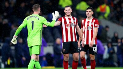 Sheffield United goalkeeper Dean Henderson, left, shakes hands with team mate Jack O'Connell after the draw against Tottenham Hotspur. PA