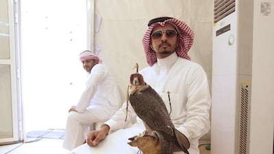 Abdel Karim Al Rashid, of Saudi Arabia, with his falcon at the Fazza Championship for Falconry, in Dubai. Jeffrey E Biteng / The National