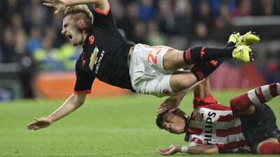Luke Shaw is tackled by PSV Eindhoven defender Hector Moreno, a tackle that resulted in a broken leg for the Manchester United player . John Thys / AFP