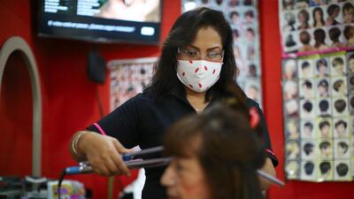 A stylist combs a woman's hair at "Imagen" beauty salon in Mexico City, Mexico. Reuters