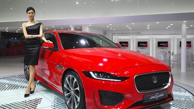 A model poses with a Jaguar XE at the show. Jung Yeon-Je / AFP