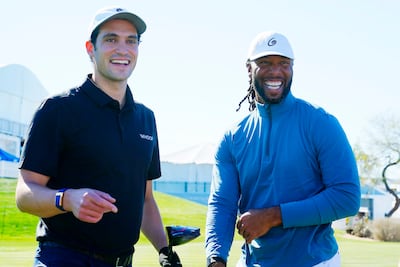 Former Arizona Cardinals NFL wide receiver Larry Fitzgerald, right, shares a laugh with Whoop CEO Will Ahmed. AP