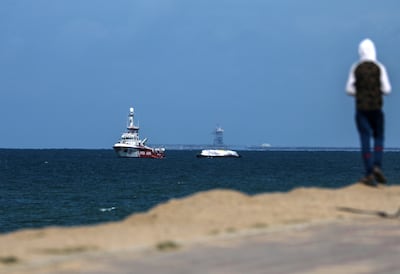 A woman watches from Gaza as the Open Arms ship and its aid cargo approach the shore. EPA