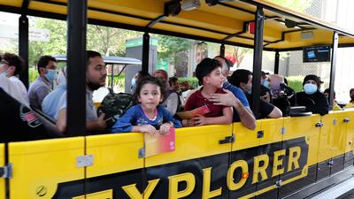 Visitors enjoy a ride on an explorer train at the Expo 2020 site in Dubai. Pawan Singh / The National