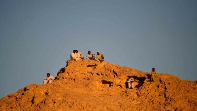 People gather on a hilltop during the match at the Khalifa bin Zayed Stadium in Al Ain. AFP